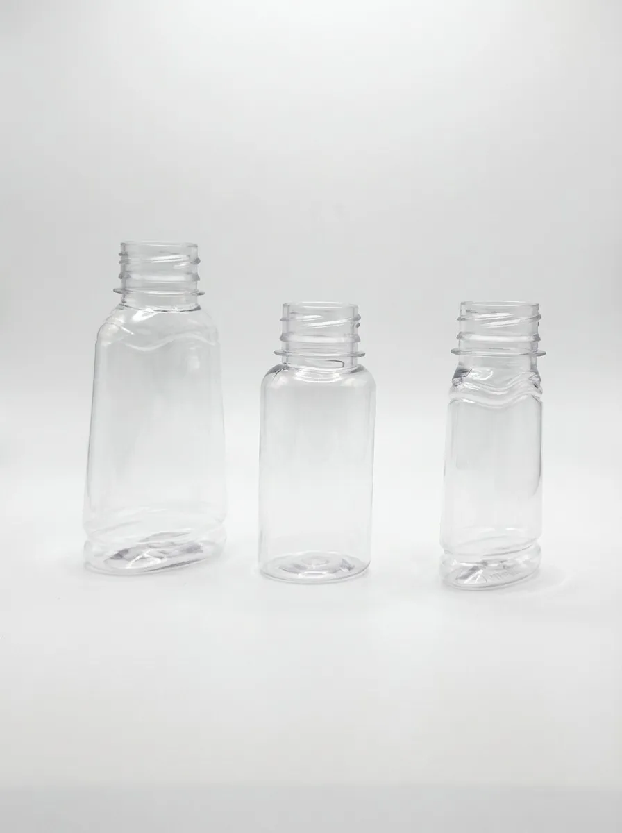 Three small clear PET bottles in descending sizes